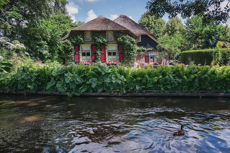 View of a blooming garden in front of the house of the Dutch town Giethoorn.の写真素材