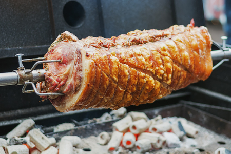 Delicious role pork wrapped in  bacon and spices on the barbequeの写真素材