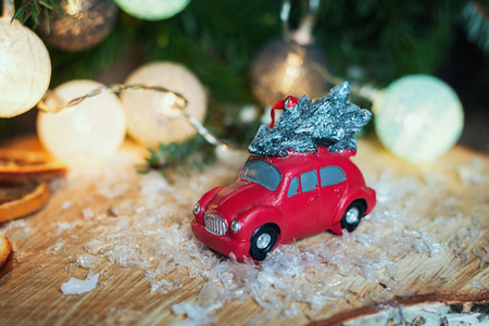 Zaandam, Netherlands, January 8, 2017:  Small red car in front of a Christmas branch decorated with illuminated christmas ballsの写真素材