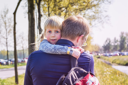 April  19, 2014, Haarzuilens, The Netherlands: Daughter is carried to the car by her father after a tired day at the Elf Fantasy Fair (Elfia) is an outdoor fantasy event at Castle de Haarのeditorial素材