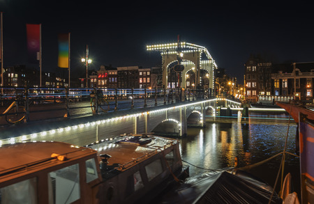 Amsterdam, Netherlands, December 16, 2017: The Magere Bridge over the river Amstel with in the background the characteristic canals buildings in the old center of Amsterdam.のeditorial素材