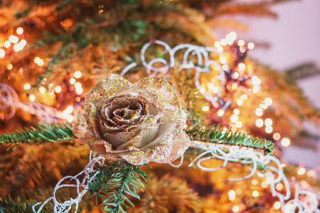 Christmas branch decorated with a golden Christmas rose.の写真素材