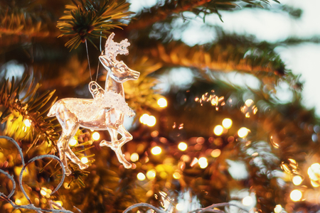 Christmas greeting in  a Christmas branch decorated with a glass deer.の写真素材