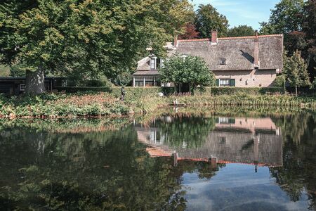 Rozendaal, Netherlands, 25 August 2019:  Beautifull country house with a reflection in the pond of the park  Rozendael castleのeditorial素材