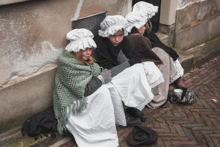 Deventer, Netherlands, December 15, 2018: Four little girls begging on the street during the Dickens Festival in Deventerのeditorial素材