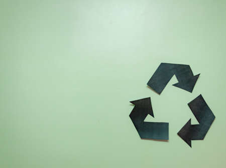 isolated symbol about recycling on a bright green background. symbol made of paperの写真素材