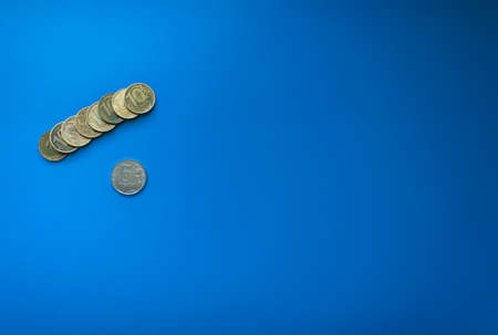 stack of ten ruble coins leeit on the left on a blue background isolated. free space for text, Russian ruble, Russian moneyの写真素材