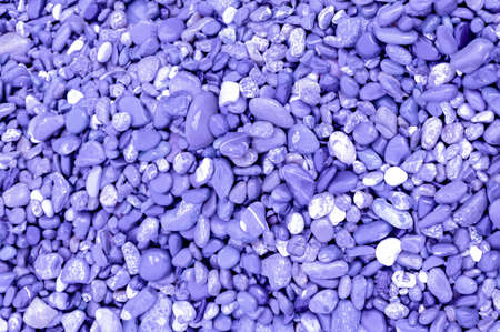 texture background in color of 2022. purple texture background. pebbles on beach, space for textの写真素材