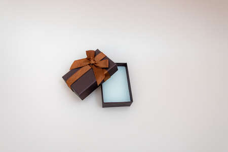 brown gift box on isolated background. open jewelry box, jewelry mockup. concept of shopping, holiday, gift, sales. place for textの写真素材