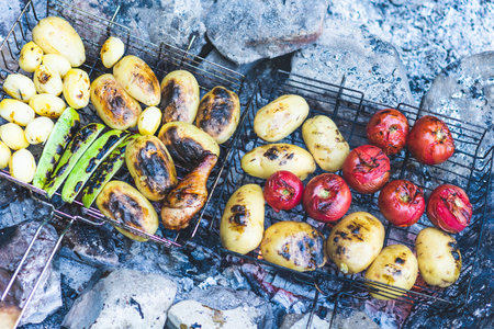 Grilled meats and vegetables are ready for the dinner party.  Delicious grilled potatoes and other...