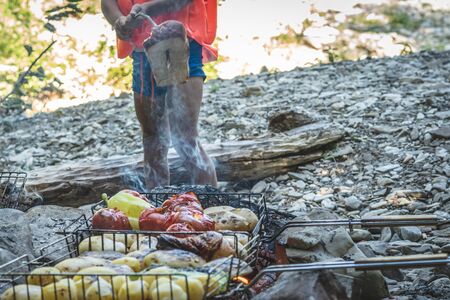 children roasting bread on a fire during a picnic in the forestの写真素材