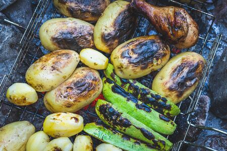 Grilled meats and vegetables are ready for the dinner party.  Delicious grilled potatoes and other vegetablesの写真素材