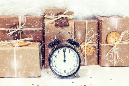 Christmas handmade gift boxes decorated with craft paper, cookies, snowflakes and clock. Merry christmas greeting card. Winter xmas holiday theme. Happy New Year.の写真素材