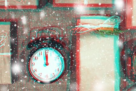 Christmas handmade gift boxes decorated with craft paper, branch and snowflake on sackcloth background top view. Merry christmas greeting card, frame. Winter xmas holiday theme. Glitch effectの写真素材