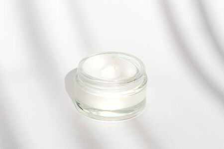 White facial cream jar. Beauty concept. Minimalistic background with facial skincare cosmetic products. Spa concept. Beauty blogger, salon treatments conceptの写真素材