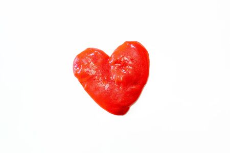 Red glitter slime in the form of a heart on whit background. Toy antistress. Toy for the development of hand motor skills.の写真素材