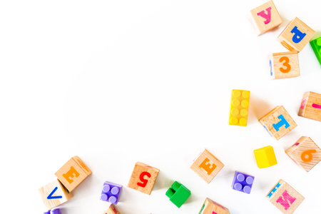 Colorful baby toys on white background. Frame from developing wooden blocks, cars and puzzles....