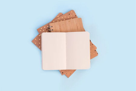 Stack of open notebooks for memories lying on a white table, office, valentines day concept. Flat...