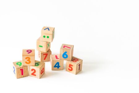 Kids toys wooden cubs with numbers on white background. Developing wooden blocks. Natural, eco-friendly toys for children. Top view. Flat lay. Copy space.の写真素材