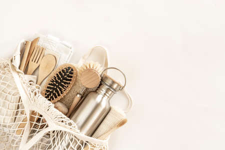 Zero waste concept. Eco-friendly accessories - bamboo cutlery, eco-friendly bag, reusable water bottle, hairbrush and toothbrush. No plastic, eco-friendly lifestyle. Top view, flat lay.の写真素材