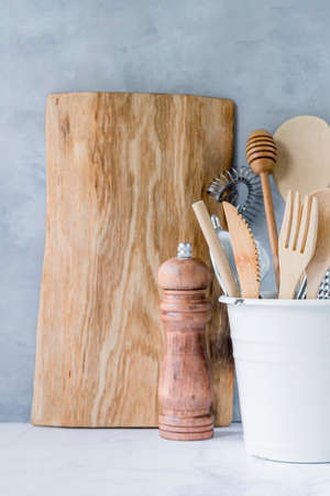 Stylish kitchen background with kitchen utensils on marble countertop.の写真素材
