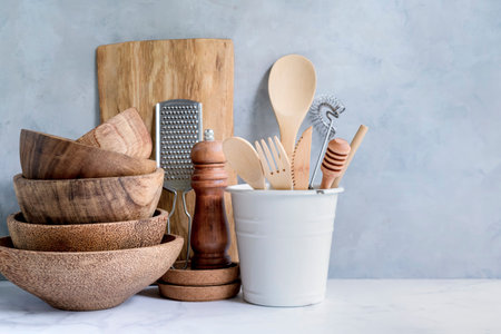 Stylish kitchen background with kitchen utensils on marble countertop, empty space for text, front...