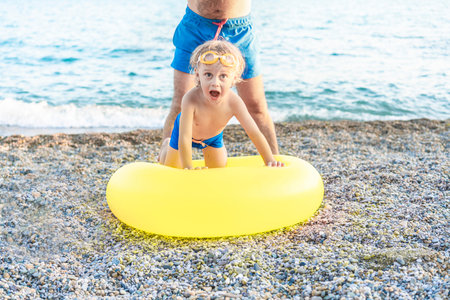 Father with his son enjoying their summer vacation by the ocean.