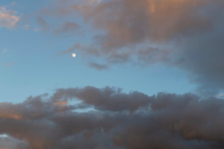 Bright moon on evening sky with gray clouds. nature backgroundの写真素材
