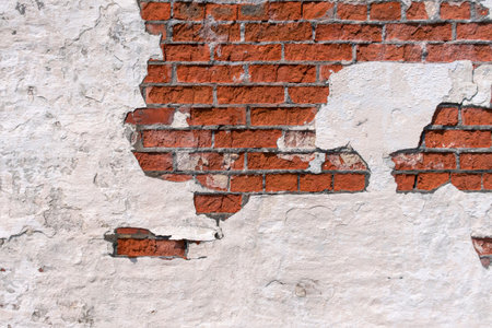 Old red brick wall. White plastic peeling. Background image with copy space