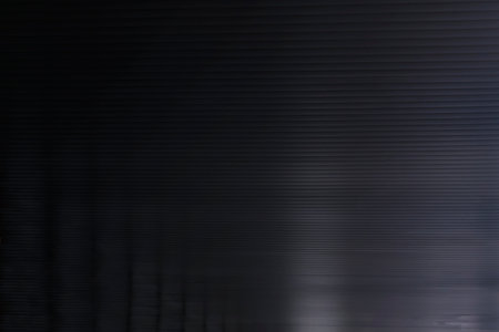 Striped dark gray surface with some highlights and reflections. Soft focus. Background imageの写真素材