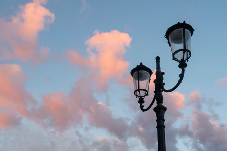 Street lantern against dusk sky with pink clouds.の写真素材
