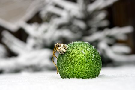 New Year's ball in a snow on a background of a fur-tree.の写真素材