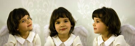 Threefold portrait of the little girl with wingsの写真素材