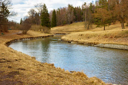 Spring landscape with a river on the sunny day. The Park of Pavlovsk. Saint Petersburg. Russia.の写真素材