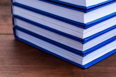Stack of books on wooden background