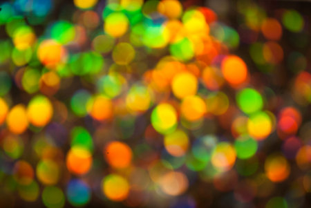 Christmas background. Festive glowing color overflows. Defocused chaotic circles Blurred bokeh.