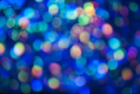 Christmas background. Festive glowing color overflows. Defocused chaotic circles Blurred bokeh.の写真素材