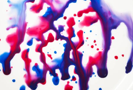 Spreading drops of paint, blue, purple, red. Art background. Abstraction.の写真素材