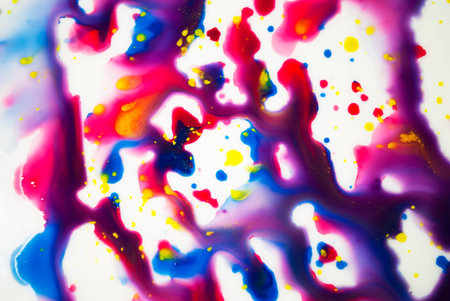 Spreading drops of paint, blue, purple, red, yellow. Art background. Abstraction.