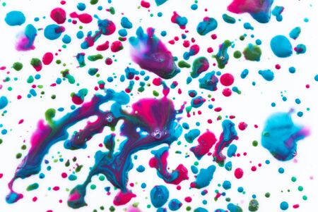 Spreading drops of paint, pink, blue color. Art background. Abstraction.の写真素材
