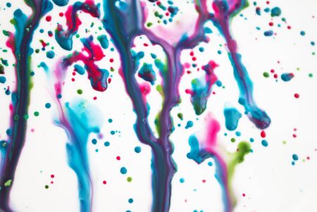 Spreading drops of paint, pink, blue, green. Art background. Abstraction.の写真素材