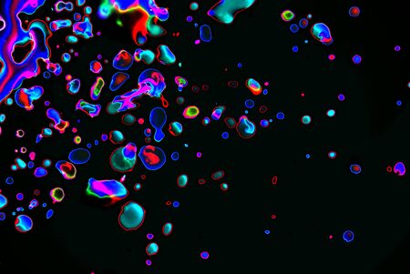Bright drops on a black background of blue, orange, blue, purple. Art background. Abstraction. Neonの写真素材