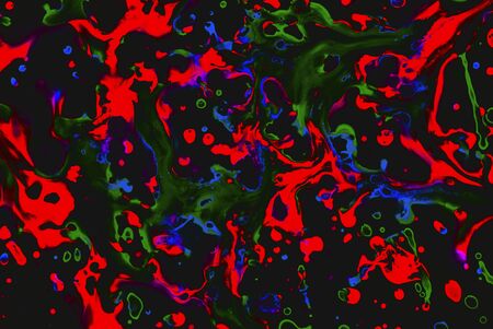 Rainbow drops and stains of paint of red, blue, green colors on a black background. Art image. Abstractionの写真素材
