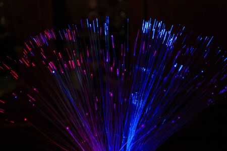 Pink and blue glow sticks on a black backgroundの写真素材