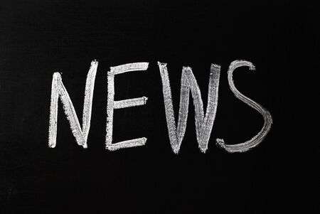 White white lettering on black blackboard Newsの写真素材