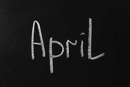 White white lettering on black chalkboard Aprilの写真素材