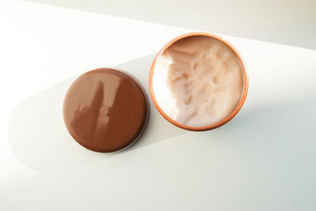 Bottle of body cream on a white background. Hard shadow, white background. Place for text. Flat lay....