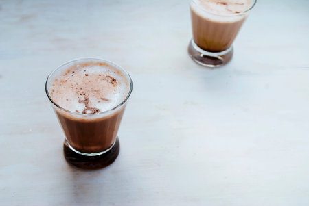 Two glasses of latte on a white background. Top view. Place for text