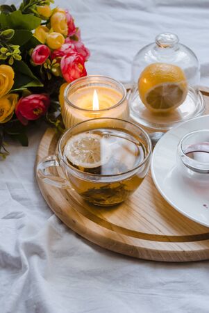 Breakfast in bed. Homeliness. Lemon tea close-up.の写真素材
