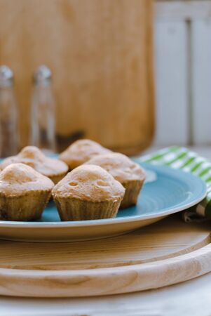 Decorated homemade muffins on a blue plate.の写真素材